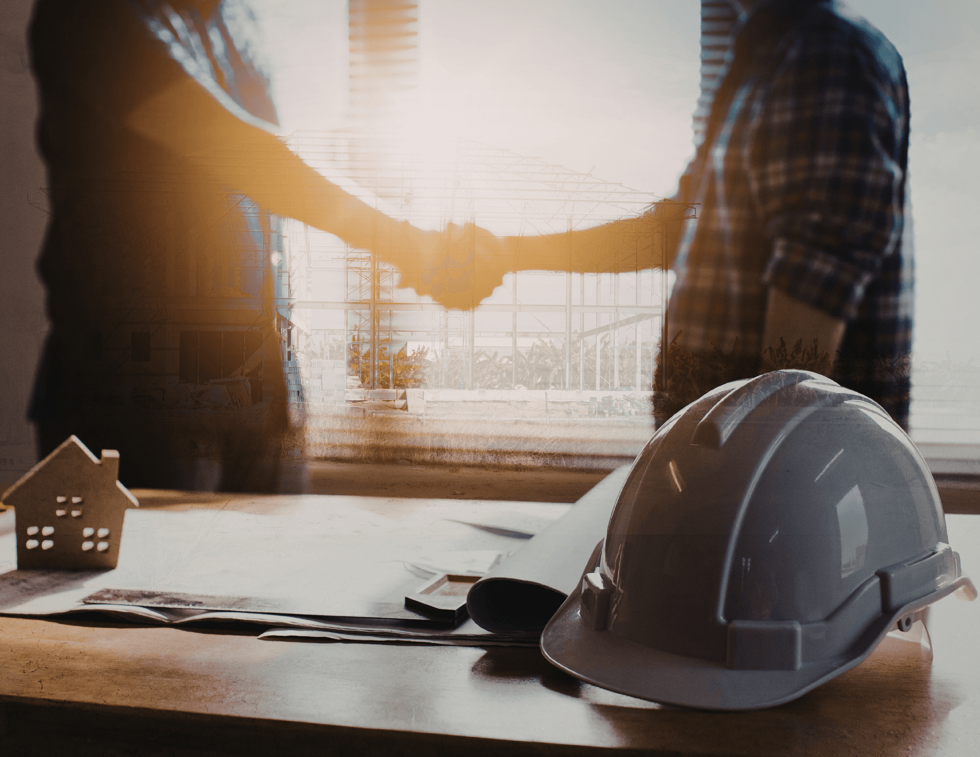 Real estate partnership — handshake at construction site